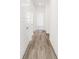 Hallway featuring wood-look flooring and pristine white doors, walls, and trim at 4327 Persian St, Greenwood, IN 46143