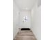 Bright hallway with wood-look flooring and fresh white paint leading to a front door at 4327 Persian St, Greenwood, IN 46143