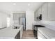 Modern kitchen with stainless steel appliances, grey cabinets, island and white subway tile backsplash at 4327 Persian St, Greenwood, IN 46143