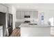 Kitchen with stainless steel appliances, gray cabinetry, and a spacious island with granite countertops at 4327 Persian St, Greenwood, IN 46143