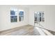 Bright living room features hardwood floors, large windows and sliding glass doors to the outdoors at 4327 Persian St, Greenwood, IN 46143