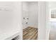 Mudroom featuring built-in bench, coat hooks, and wood-look flooring at 4327 Persian St, Greenwood, IN 46143