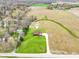 Aerial view of a charming two-story home on a spacious lot, set amidst serene fields and scattered trees at 4339 W Briarwood Rd, Monrovia, IN 46157