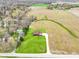 Aerial view of a charming two-story home on a spacious lot, set amidst serene fields and scattered trees at 4339 W Briarwood Rd, Monrovia, IN 46157