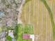 Overhead shot of house with a spacious yard, adjacent fields, and a long driveway, capturing a serene rural setting at 4339 W Briarwood Rd, Monrovia, IN 46157
