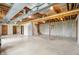 Large unfinished basement with exposed ceiling and ductwork, painted cement flooring, staircase, and support pillars at 4339 W Briarwood Rd, Monrovia, IN 46157