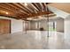 Large unfinished basement with exposed ceiling, support pillars, windows and sliding glass door leading to the outdoors at 4339 W Briarwood Rd, Monrovia, IN 46157