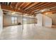 Large unfinished basement with exposed ceiling, gas heater, windows and sliding glass door leading to the outdoors at 4339 W Briarwood Rd, Monrovia, IN 46157