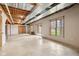 Unfinished basement with exposed ceiling and ductwork, painted cement flooring, sliding glass door, windows, and gas heater at 4339 W Briarwood Rd, Monrovia, IN 46157