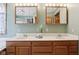 Double vanity with mirrors, bright lighting, and classic fixtures in a well-lit bathroom at 4339 W Briarwood Rd, Monrovia, IN 46157