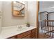 Neutral bathroom with a wood vanity, built-in medicine cabinet, and view into the next room at 4339 W Briarwood Rd, Monrovia, IN 46157