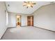 Large bedroom featuring plush carpeting, neutral walls, and a view into an attached bathroom at 4339 W Briarwood Rd, Monrovia, IN 46157