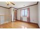 This bedroom features hardwood floors, crown molding, a ceiling fan, and a window with curtains at 4339 W Briarwood Rd, Monrovia, IN 46157