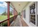 Long, covered porch with chairs, offering an expansive outdoor living space with overhead lighting at 4339 W Briarwood Rd, Monrovia, IN 46157