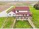 Aerial view of the home showing elevated patio, red roof, and farm fields nearby at 4339 W Briarwood Rd, Monrovia, IN 46157