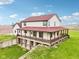 Back of house features a large raised porch, walk-out basement, and ample yard space at 4339 W Briarwood Rd, Monrovia, IN 46157