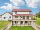 Exterior showcasing the home's red roof, raised porch, and partial basement at 4339 W Briarwood Rd, Monrovia, IN 46157