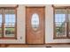 Elegant front door with decorative glass detailing, framed by sidelight windows, enhancing curb appeal at 4339 W Briarwood Rd, Monrovia, IN 46157