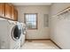 Well-lit laundry room featuring a Samsung washer and dryer with overhead storage at 4339 W Briarwood Rd, Monrovia, IN 46157