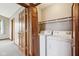 Practical laundry area featuring a white washer and dryer, with a convenient shelf for storage at 4339 W Briarwood Rd, Monrovia, IN 46157