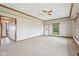 Bright living room with light walls, wood trim, back door and view to the kitchen at 4339 W Briarwood Rd, Monrovia, IN 46157