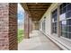 Covered lower-level patio with brick columns, concrete floors, large windows, and bright natural light at 4339 W Briarwood Rd, Monrovia, IN 46157