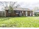 Backyard of brick house with green grass and a wooden fence at 438 Park Dr, Greenwood, IN 46143