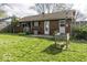 Backyard of brick house with green grass and a wooden fence at 438 Park Dr, Greenwood, IN 46143