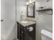 Bathroom featuring a vanity with a framed mirror, marble countertop, and a toilet at 438 Park Dr, Greenwood, IN 46143