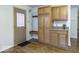 Practical entryway with storage cabinets, a built-in bench, and wood-look flooring at 438 Park Dr, Greenwood, IN 46143