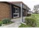 Inviting covered porch with brick detailing and manicured bushes at 438 Park Dr, Greenwood, IN 46143