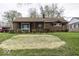 Quaint brick home featuring a tidy front yard and covered porch at 438 Park Dr, Greenwood, IN 46143