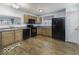 Functional kitchen featuring wood-look floors and black appliances at 438 Park Dr, Greenwood, IN 46143