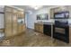 Traditional kitchen featuring wood cabinets, black appliances, and wood-look flooring at 438 Park Dr, Greenwood, IN 46143