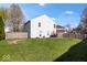 A well-maintained backyard with lush grass and a charming fire pit area at 4613 Walker St, Greenwood, IN 46143