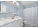Fresh bathroom with white vanity, ample storage, and a stylish shower curtain at 4613 Walker St, Greenwood, IN 46143