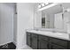 Clean bathroom features a double sink vanity, a large mirror, and a walk-in shower at 4613 Walker St, Greenwood, IN 46143