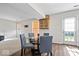 Bright dining area features a glass table, gray chairs, wood floors, and a decorative wall cabinet at 4613 Walker St, Greenwood, IN 46143