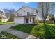 Traditional two-story home with a well-manicured lawn, attached garage, and inviting curb appeal at 4613 Walker St, Greenwood, IN 46143