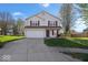 Charming two-story home features a well-maintained lawn and a two-car garage at 4613 Walker St, Greenwood, IN 46143