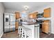 Stylish kitchen with wood cabinets, stainless steel appliances, and a functional kitchen island at 4613 Walker St, Greenwood, IN 46143