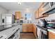 Well-lit kitchen with stainless steel appliances and a central island for seating at 4613 Walker St, Greenwood, IN 46143