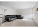 Open living space with a large, comfortable black sectional sofa and neutral carpet at 4613 Walker St, Greenwood, IN 46143