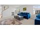 Bright living room with blue sofas, plush carpet, and lots of natural light at 4613 Walker St, Greenwood, IN 46143