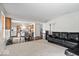 Open-concept living area connecting to the kitchen, featuring a black leather sectional sofa at 4613 Walker St, Greenwood, IN 46143