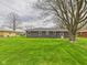 Expansive backyard featuring lush green lawn and the rear exterior of the home at 4715 Southern Ave, Anderson, IN 46013