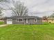 Charming single-story home featuring an attached garage and a well-maintained front yard with mature trees at 4715 Southern Ave, Anderson, IN 46013