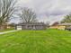 Single-story home with attached garage, concrete driveway and well-maintained lawn with mature trees and landscaping at 4715 Southern Ave, Anderson, IN 46013
