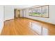 Bright living room with hardwood floors and a large window showcasing natural light and providing outdoor views at 4715 Southern Ave, Anderson, IN 46013