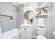 Nicely decorated bathroom featuring neutral-colored tile, modern vanity, and an accent mirror at 4719 Evanston Ave, Indianapolis, IN 46205
